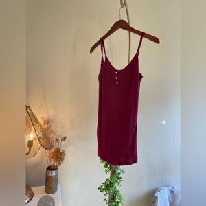 Thin strap magenta shirt with small buttons.